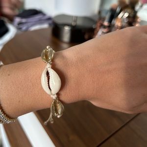 White and gold seashell bracelet.